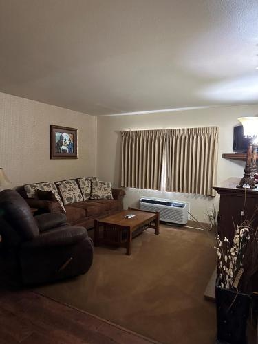 a living room with a couch and a table at First Gold Gaming Resort in Deadwood