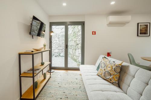 a living room with a couch and a table at Courtyard Oporto Design Apartments by Vacationy in Porto