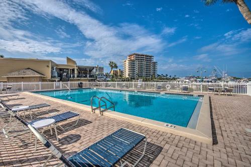 a swimming pool with lounge chairs and a building at Destin Ground-Level Condo with Private Beach Access in Destin