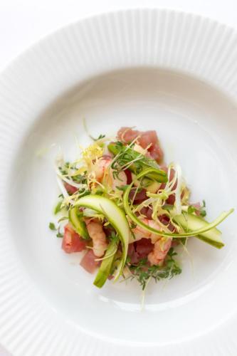 a white plate with a salad with shrimp and vegetables at Hotel Sørup Herregaard in Ringsted
