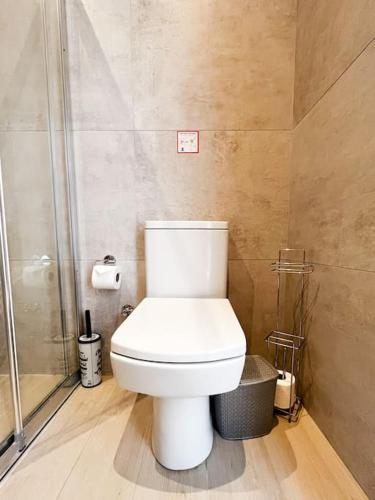 a bathroom with a white toilet and a shower at Dreamview Suite Beachfront Getaway in Mağusa