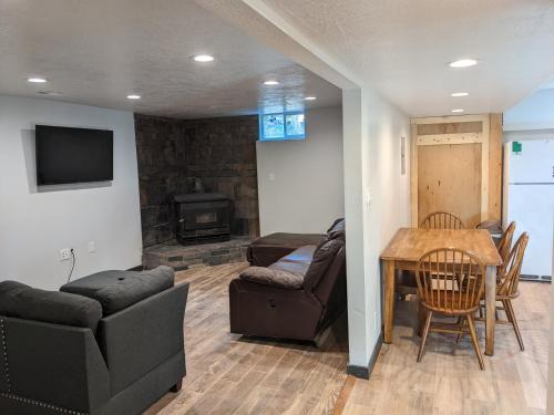 a living room with a couch and a table at Canyon Coze - Ski, Board, Sled, Bike, Hike in Ogden