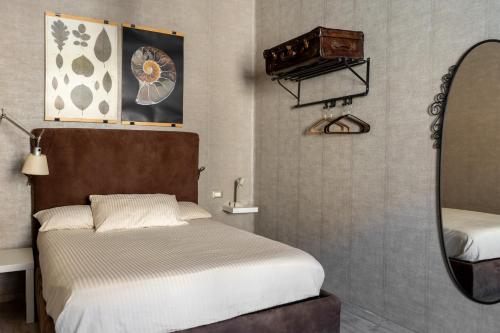 Ένα ή περισσότερα κρεβάτια σε δωμάτιο στο L'esclusivo Carducci 14: tra Centro Storico e Mare