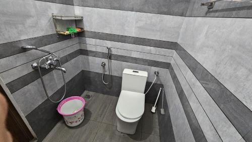 a bathroom with a toilet and a shower at Tea Mitra Holiday Homes in Vagamon