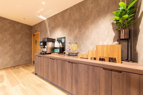 a coffee shop counter with a coffee maker on it at Holiday Inn Blackpool by IHG in Blackpool