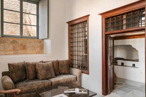 a living room with a couch and a window at Hydrea Exclusive Hospitality in Hydra