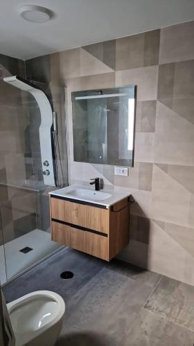 a bathroom with a sink and a toilet and a mirror at Gaviotas Beach Golf in Almerimar
