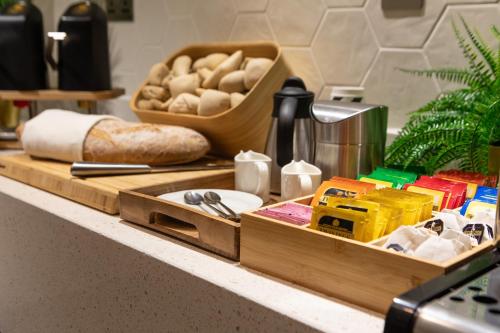 a counter top with bread and a tray of food at Holiday Inn Blackpool by IHG in Blackpool