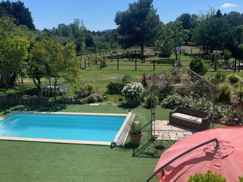 a swimming pool in a yard with a garden at BROSSARD in Cavaillon