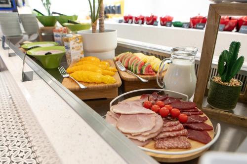 a buffet with a plate of meat and other foods at Holiday Inn Blackpool by IHG in Blackpool
