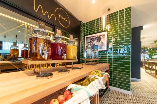 a store with green tiled walls and jars of honey at Holiday Inn Blackpool by IHG in Blackpool