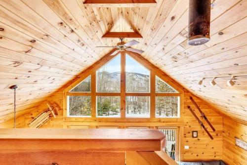 a room with a large window in a log cabin at Gorgeous Chalet! VIEWS! Hot Tub! Sleeps 12! Games in Bethel