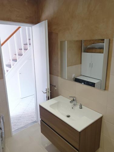 a bathroom with a sink and a mirror at Voula's maisonette in Acharavi