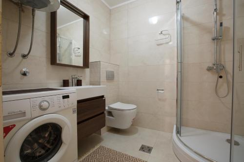a bathroom with a washing machine and a shower at Soul of the Kotor Bay in Dobrota