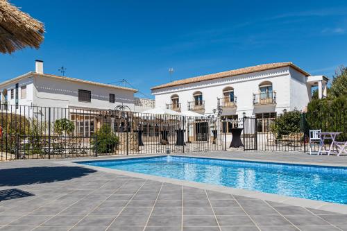 a villa with a swimming pool in front of a building at Villa Morena in Finestrat