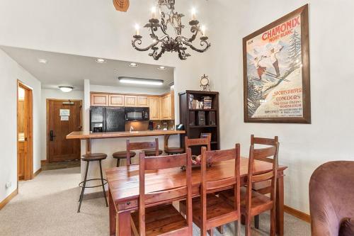 a dining room and kitchen with a table and chairs at Riverbend Lodge 217 by Great Western Lodging in Breckenridge