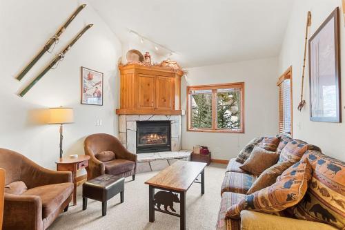 a living room with a couch and a fireplace at Riverbend Lodge 217 by Great Western Lodging in Breckenridge