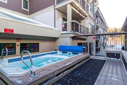 a hot tub outside of a building at Riverbend Lodge 217 by Great Western Lodging in Breckenridge