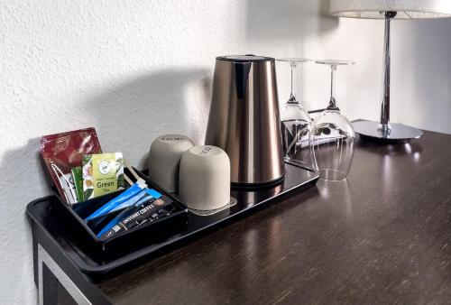 a black shelf with a blender and other items on it at Hotel Sørup Herregaard in Ringsted