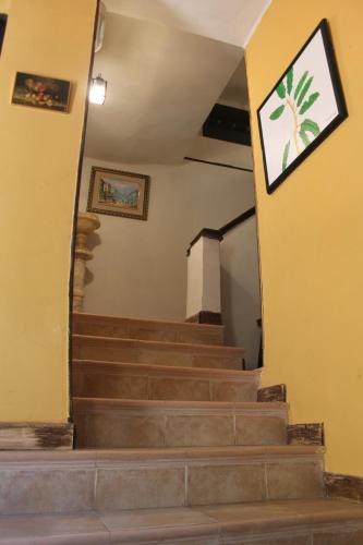 a set of stairs in a building with a picture on the wall at El Sumiciu in Mieres