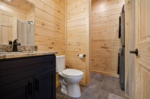 a bathroom with a toilet and a sink at Baby Bear Den in Gatlinburg