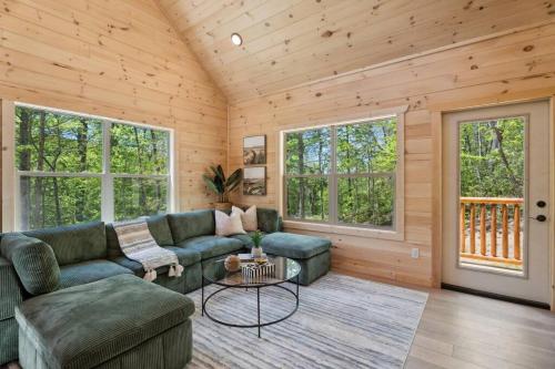 a living room with a couch and a table at Baby Bear Den in Gatlinburg