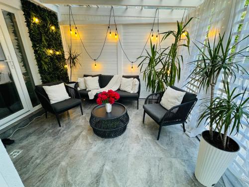 a patio with chairs and a table with flowers at Aici te simți ca acasa 2 in Iaşi