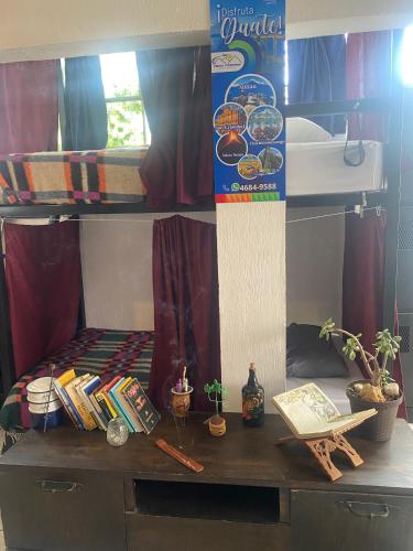 a desk in a room with a bunk bed at Nomades Hostel "The Apartment" in Panajachel