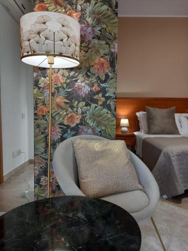 a room with a table and a chair and a bed at BAARIA PORTO rooms in Milazzo