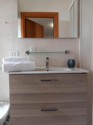 a bathroom with a sink and a mirror at BAARIA PORTO rooms in Milazzo
