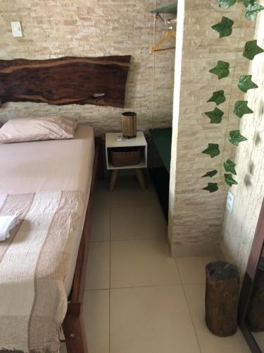 a small room with two beds and a table at Casita Cumbuco in Cumbuco