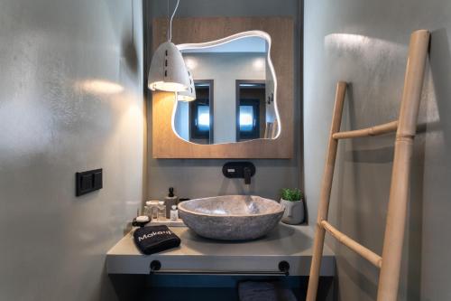 a bathroom with a bowl sink and a mirror at Stone Village Skala Maries in Skala Marion
