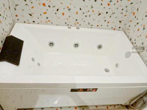 a white bath tub sitting on top of a counter at Hotel Nova Bopal in Bodakdev