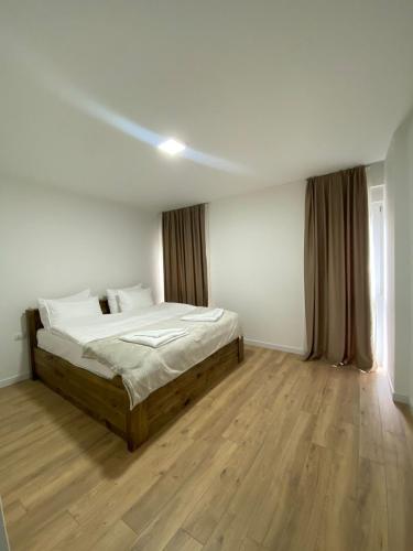 a bedroom with a bed and a wooden floor at 1863 Boutique Hotel in Peje