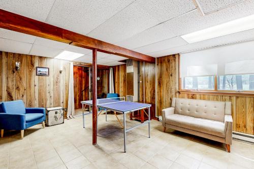 a room with a table and chairs and a couch at Main House in Ossipee
