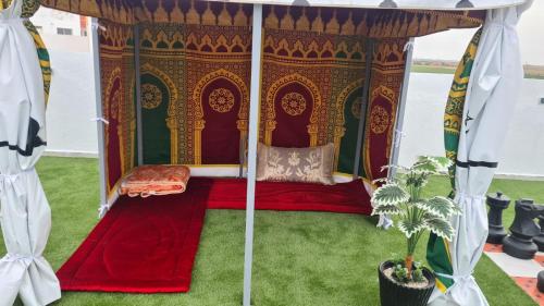 a bed in a gazebo with a plant at Camping on the rooftop close to Casablanca Airport in Dah Hammou Ben Cheïkh
