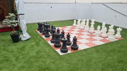 a chess board on a lawn with a giant chessboard at Camping on the rooftop close to Casablanca Airport in Dah Hammou Ben Cheïkh
