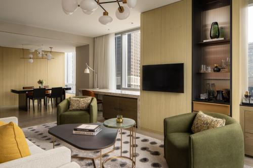 a living room with a couch and chairs and a table at Four Seasons Hotel Toronto in Toronto