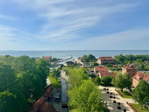 a view of a town with the ocean in the background at Pokoje Gościnne Ewa Nowicka in Frombork