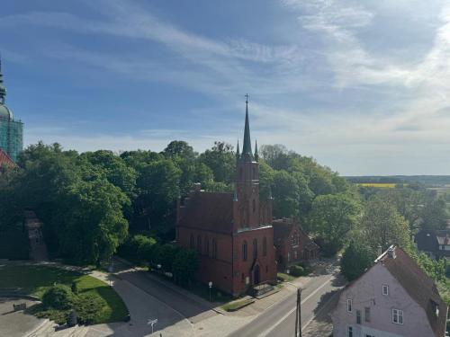 an aerial view of a church with a tall steeple at Pokoje Gościnne Ewa Nowicka in Frombork