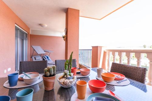 a dining room table with bowls and plates of food at Brisas Almerimar R&R in El Ejido