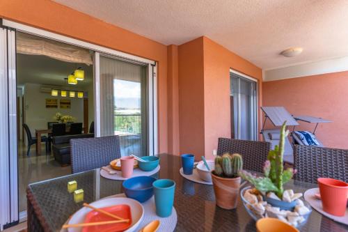 a living room with a table with plates of food at Brisas Almerimar R&R in El Ejido