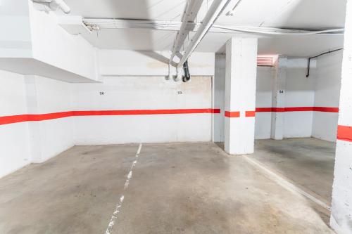 an empty room with red and white stripes on the walls at Brisas Almerimar R&R in El Ejido