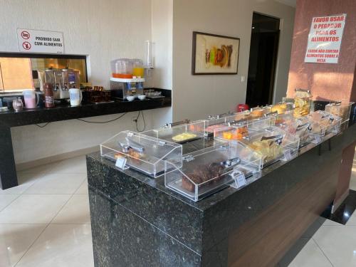 a buffet of food on a counter in a room at Hotel Barão de Limeira in Limeira