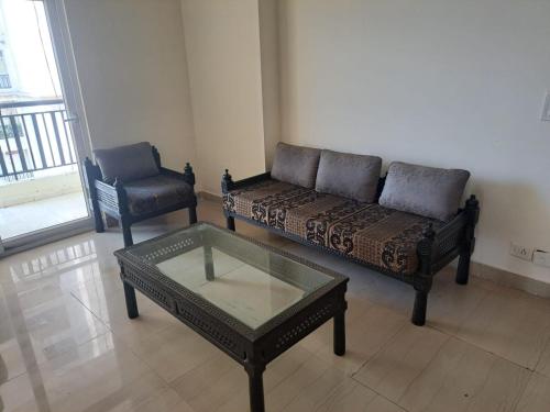 a living room with a couch and a chair at 2Bhk fully furnished flat. in Ghaziabad