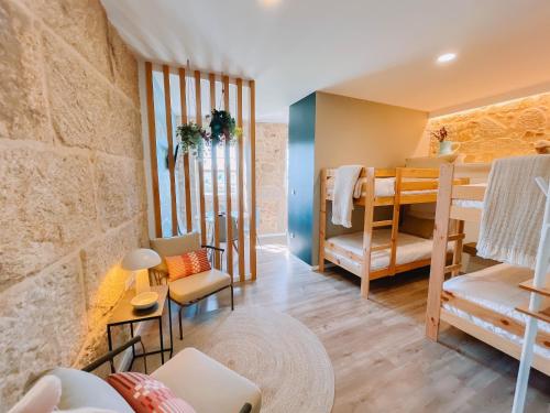 a room with two bunk beds and a living room at Just Like Home - Vilavelha Suites in Valença