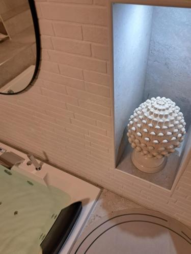 a bathroom with a white sphere in a window at MÃE Apulian Rooms in Grottaglie