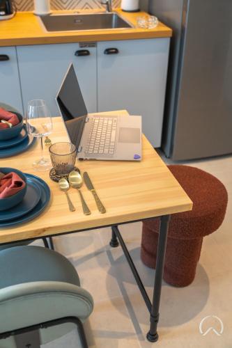 a laptop computer sitting on a table in a kitchen at Oraya - Collective 2 0 Tower A Sanctuary in Dubai Hills in Dubai