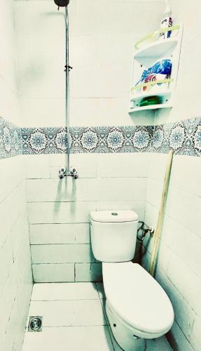 une salle de bain avec des toilettes blanches dans une chambre dans l'établissement Taghazout studio, à Taghazout