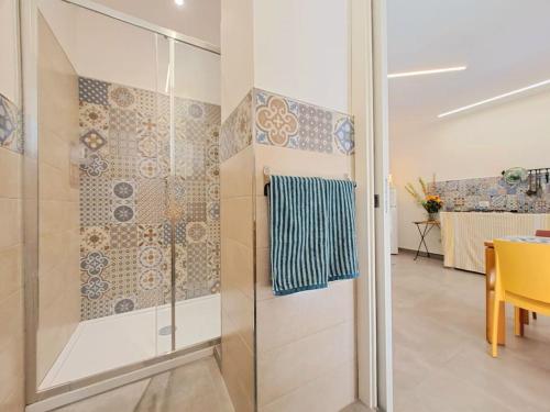 a shower with a glass door in a room at Casa Taormina in Letojanni